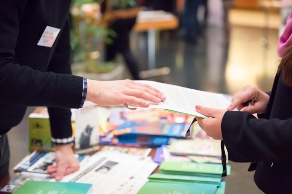 Person handling materials at conference during event