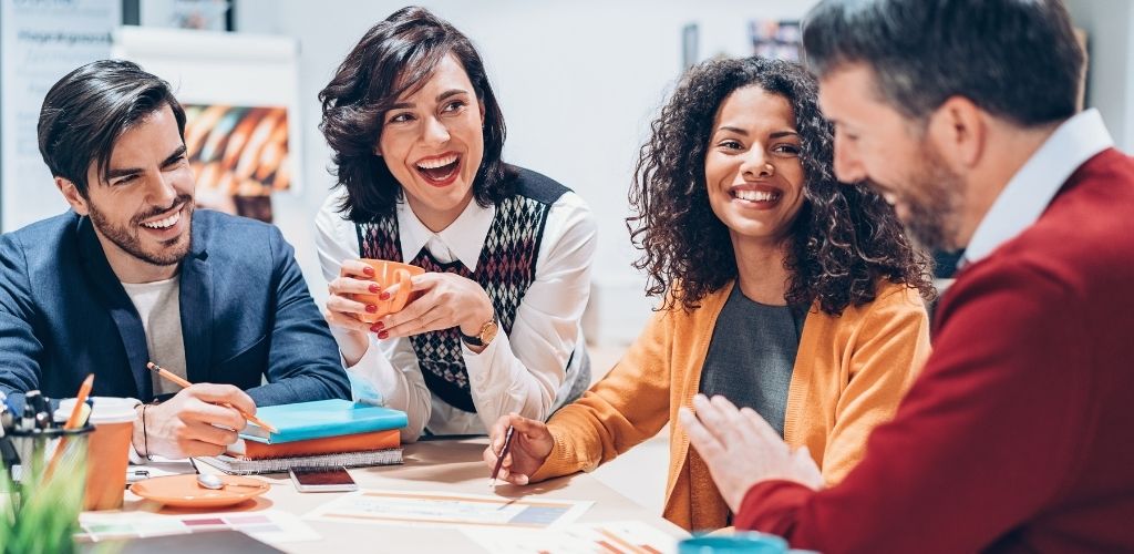 Group of people laughing in a meeting